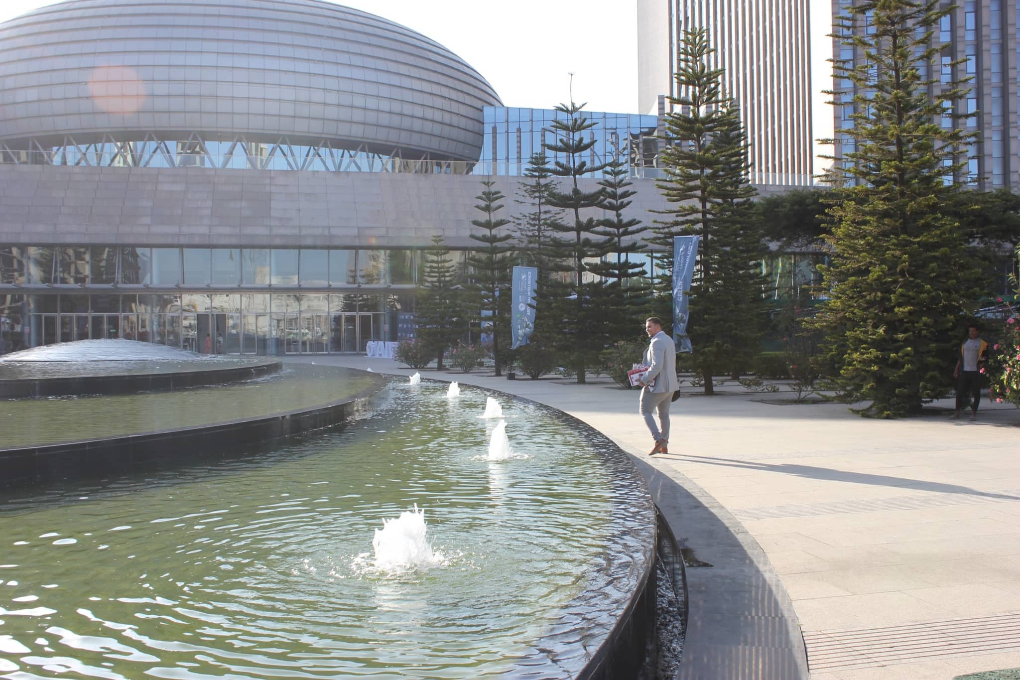 The forecourt of the African Union headquarters in Addis Ababa: a fountain pool, with the domed conference hall and the office tower behind it.